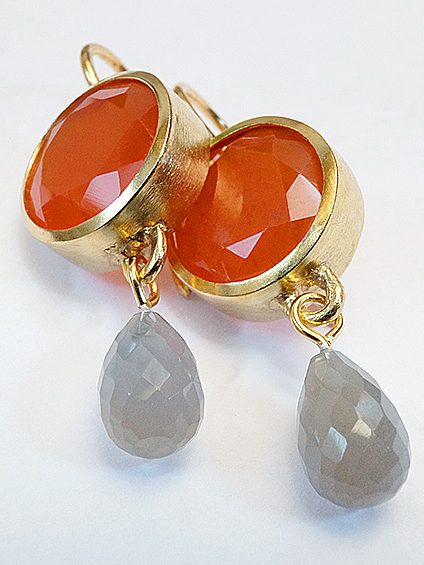Orangefarbene Karneol-Ohrringe mit grauen, tropfenförmigen Anhängern.